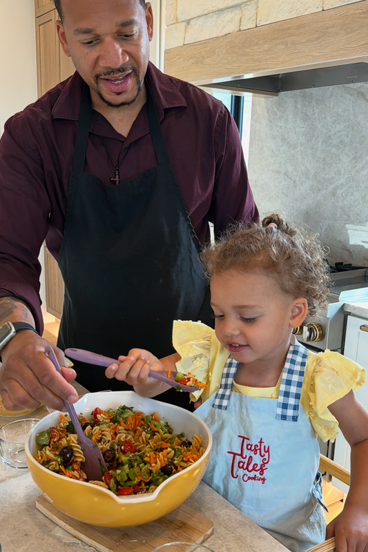 Dad and daughter making pasta salad
